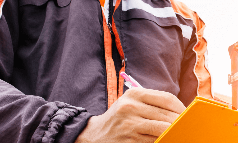 worker holding orange checklist