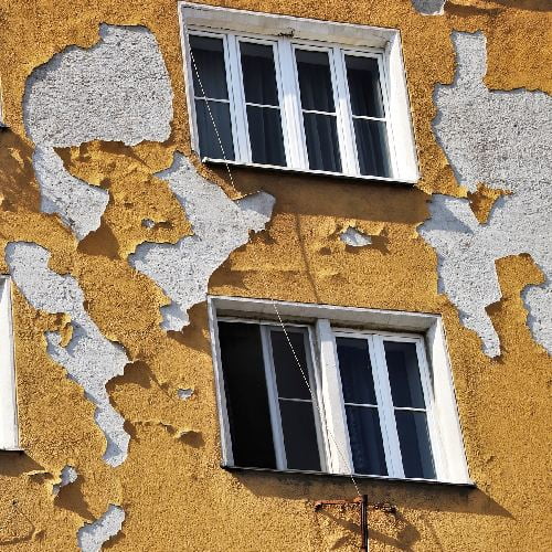 yellow building with peeling paint